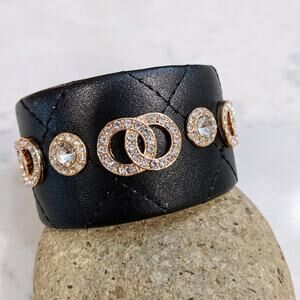 Black Quilted Bracelet Style Cuff Featuring Gold Tone Sparkle Interlocking Circl